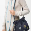 «Cats» mittlere Flamenco-Clutch aus besticktem Denim «Cats» mittlere Flamenco-Clutch aus besticktem Denim